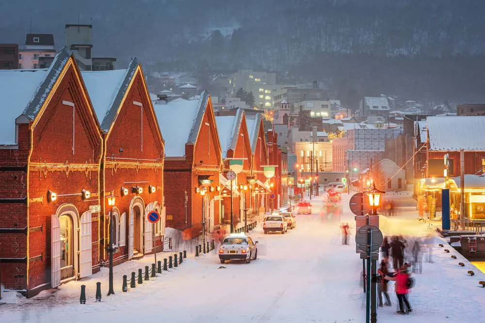 Red brick warehouses in Hakodate, Hokkaido, on a snowy evening