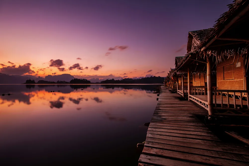 Floating raft houses on Cheow Lan Lake in Khao Sok National Park at sunset